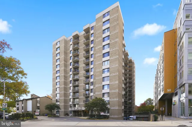 a view of a tall building next to a road