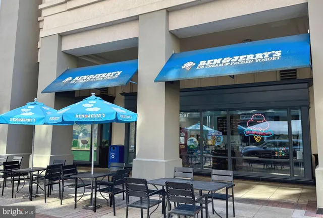 a view of a cafe with a table and chairs under an umbrella