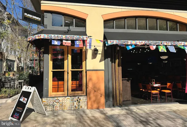 a front view of a building with retail shops