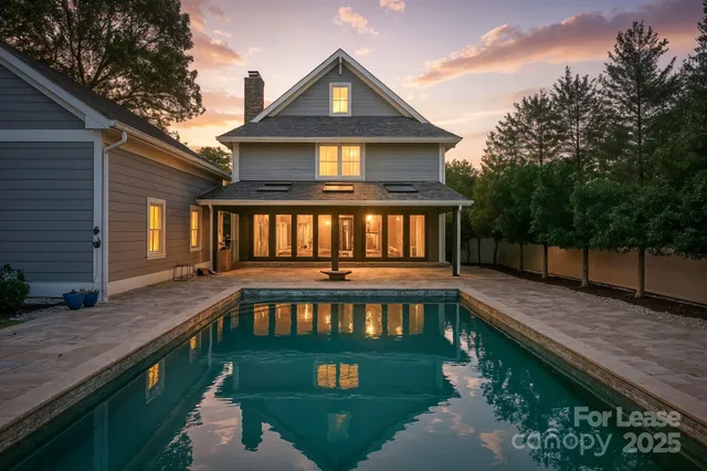 a view of a house with pool and sitting area