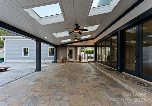 a view of a livingroom with a ceiling fan and window