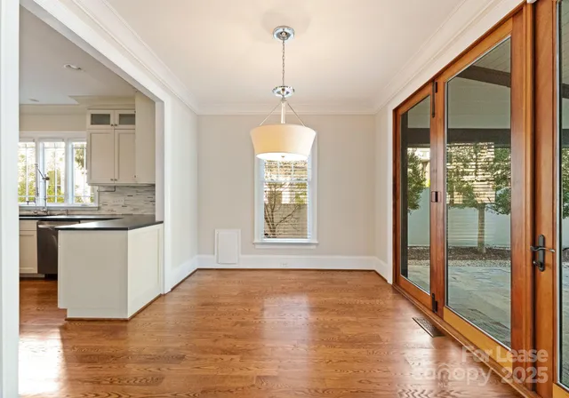a view of a kitchen with wooden floor and a ceiling fan