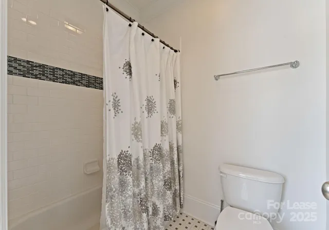 a bathroom with a shower and a toilet