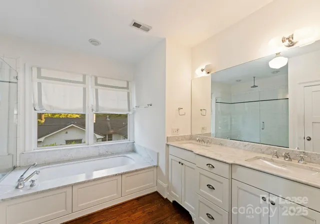 a bathroom with a granite countertop sink mirror and double