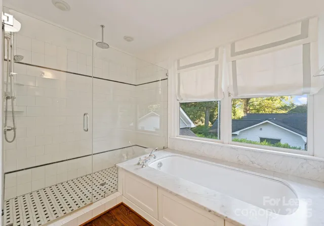 a bathroom with a bathtub and a shower