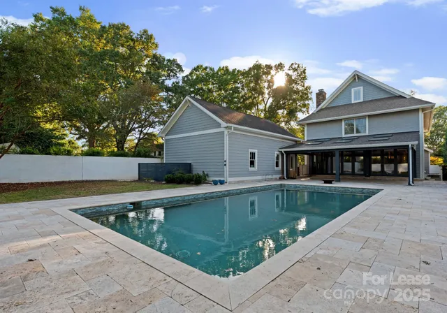 a view of house and outdoor space with swimming pool