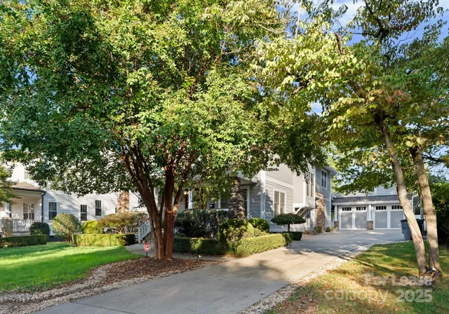 a view of a house with a tree and garden
