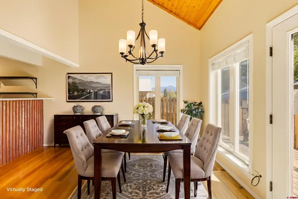 a living room with furniture fireplace and a large window