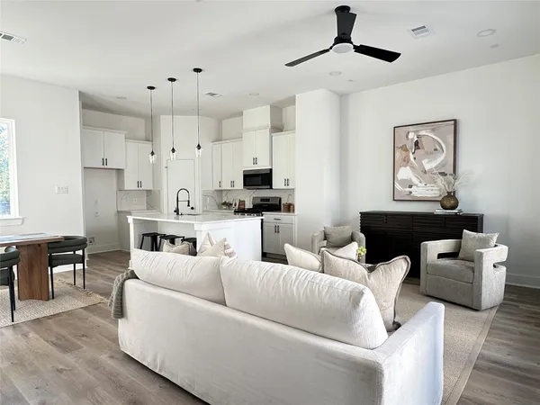 a living room with furniture and kitchen view
