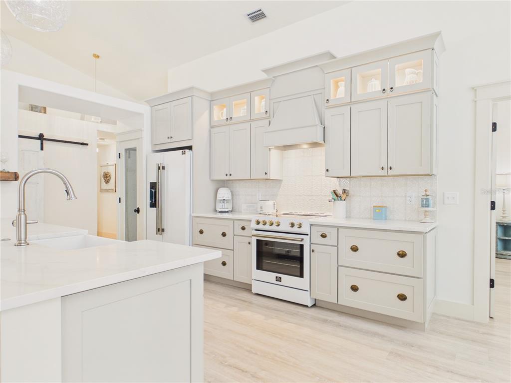 426 Long Cove Road Ormond Beach, FL 32174 - Photo 11 of 73 a kitchen with stainless steel appliances white cabinets and a sink
