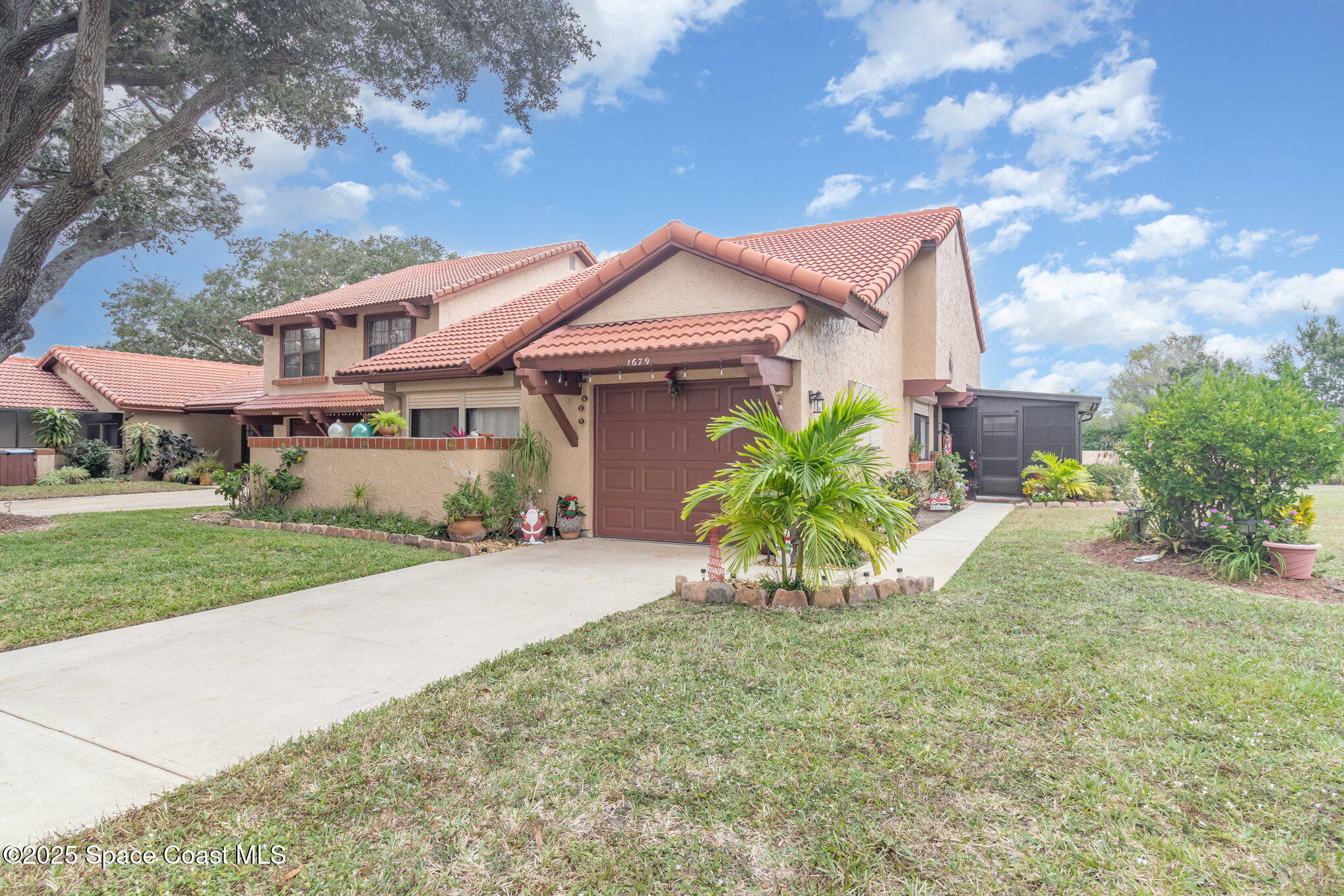1679 Dawes Road Northeast Palm Bay, FL 32905 - Photo 1 of 15 a view of a house with a yard and potted plants