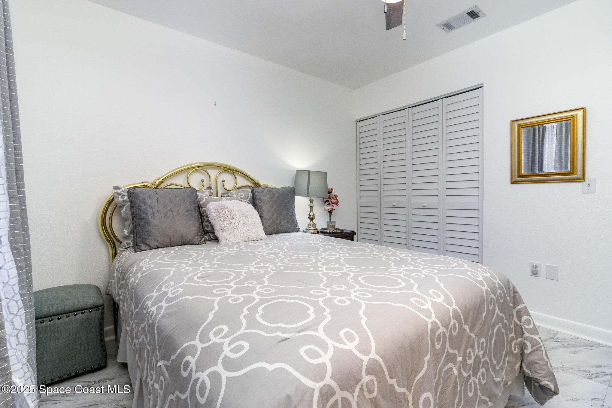 1679 Dawes Road Northeast Palm Bay, FL 32905 - Photo 11 of 15 a bedroom with a bed and a painting on the wall