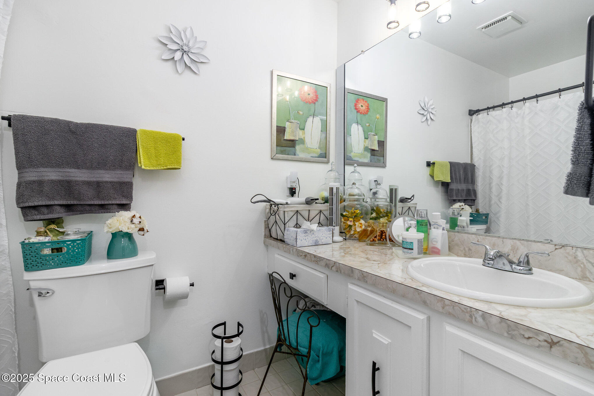 1679 Dawes Road Northeast Palm Bay, FL 32905 - Photo 12 of 15 a bathroom with a granite countertop toilet sink and mirror