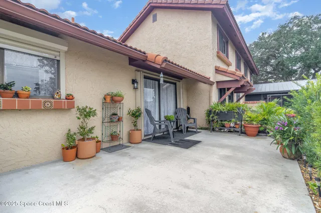 a view of a chair and table in front of a house