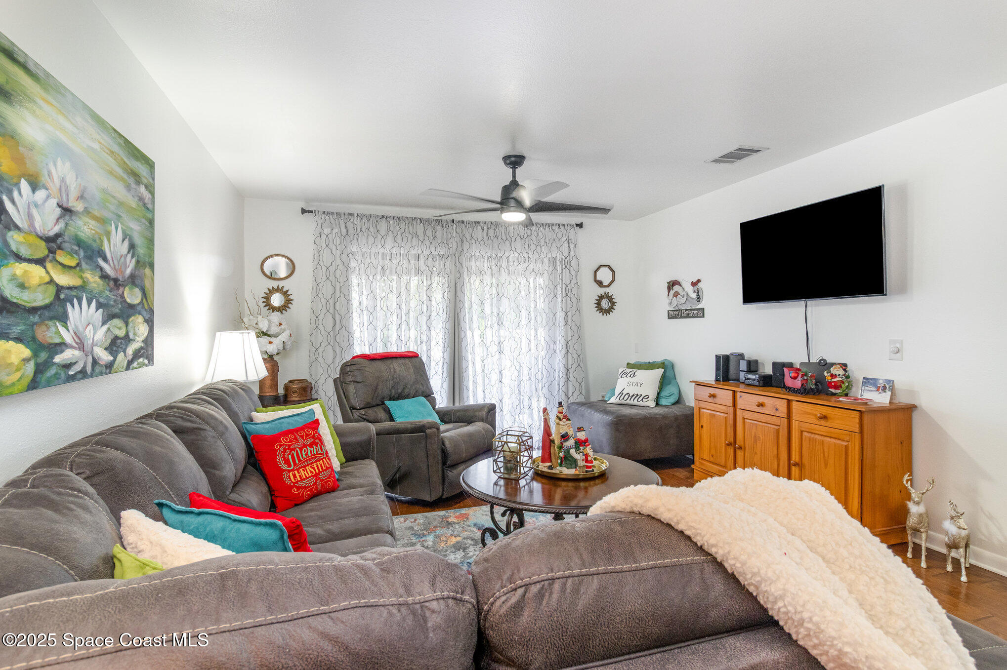 1679 Dawes Road Northeast Palm Bay, FL 32905 - Photo 2 of 15 a living room with furniture and a flat screen tv