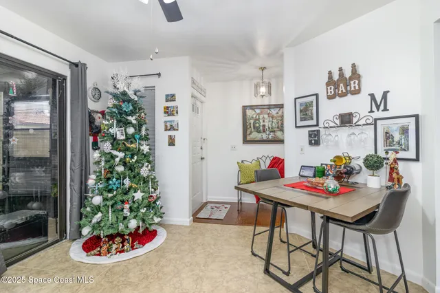 a view of a dining room with furniture and potted plant