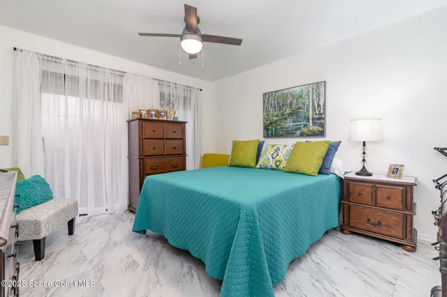 a bedroom with a bed and a tv