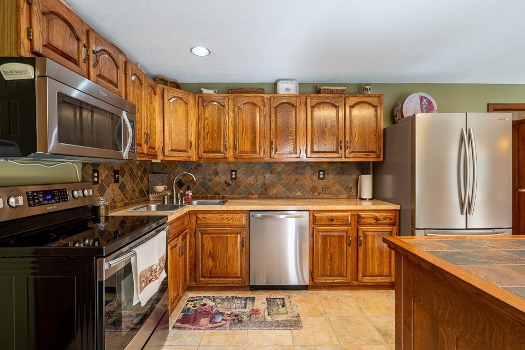 38 Zuell Hill Road Monson, MA 01057 - Photo 14 of 42 a kitchen with stainless steel appliances granite countertop a stove a sink dishwasher and a refrigerator