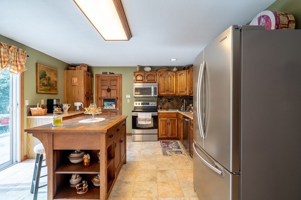 38 Zuell Hill Road Monson, MA 01057 - Photo 16 of 42 a kitchen with stainless steel appliances granite countertop a refrigerator a sink and a stove