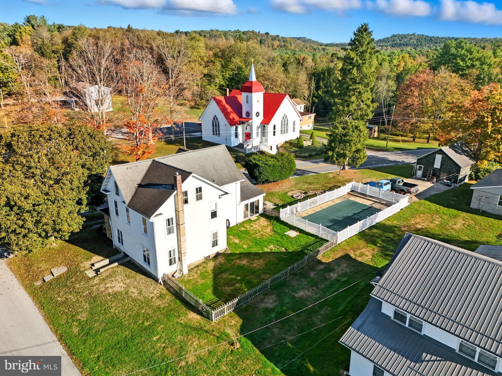 an aerial view of a house with a yard