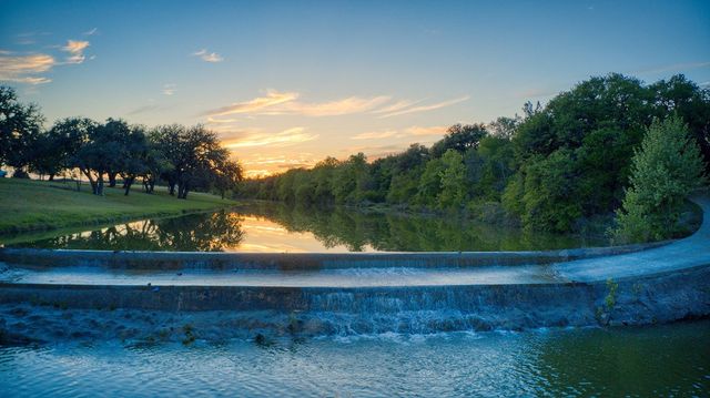 a dining hall with stainless steel appliances granite countertop a dining table chairs and view living room