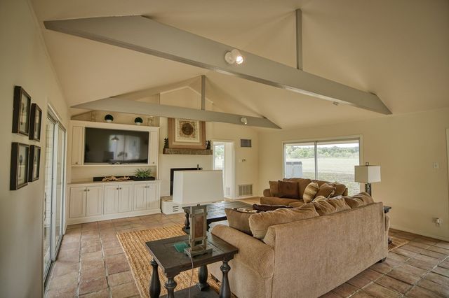 a living room with furniture window and a fireplace