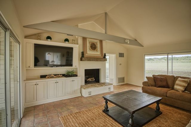 a view of a livingroom with furniture window and a fireplace