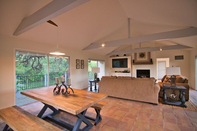 a living room with furniture a fireplace and a table