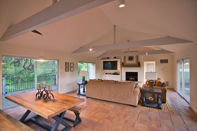 a living room with furniture and kitchen view