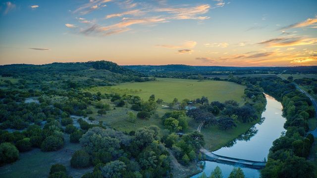 a view of a lake in middle of forest