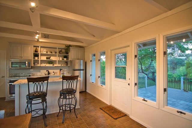 a view of a dining room with furniture and window