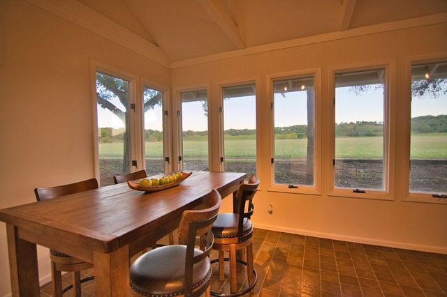 a view of a dining room with furniture and window