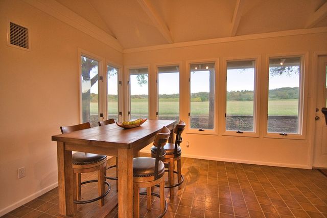 a dining room with a table chairs and balcony view