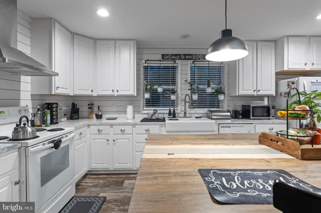 a kitchen with a sink stove and cabinets