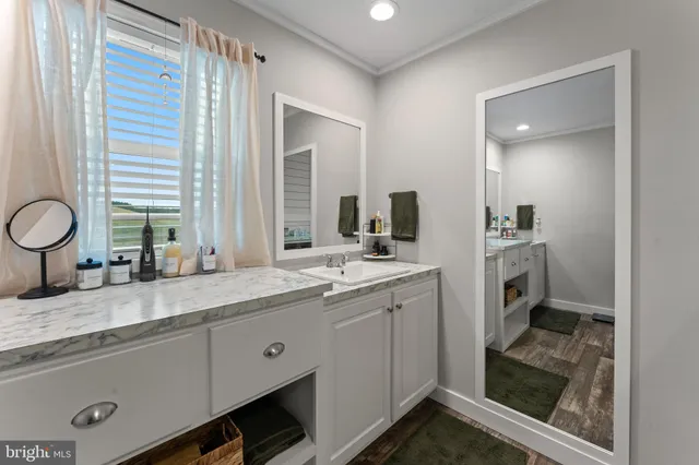 a bathroom with double vanity sinks and a mirror