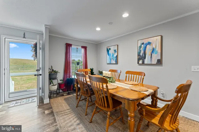 a dining room with furniture and wooden floor