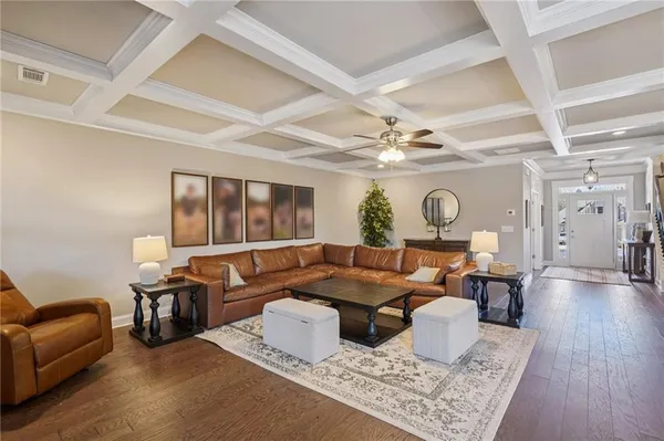 a kitchen with kitchen island granite countertop a sink cabinets and wooden floor