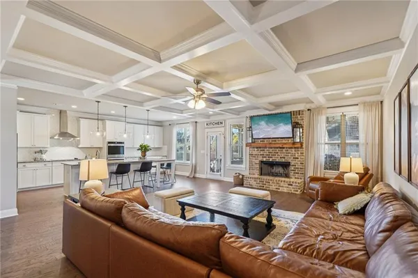 a kitchen with sink stove and living room