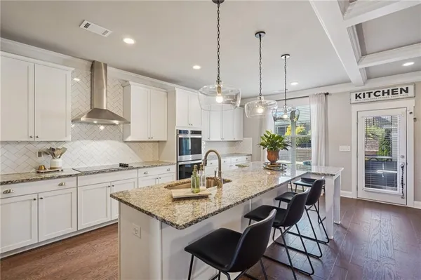 a spacious bedroom with a bed a couch and a window