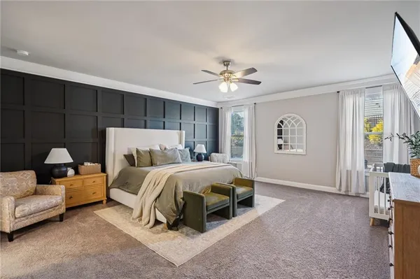 a living room with furniture and a ceiling fan