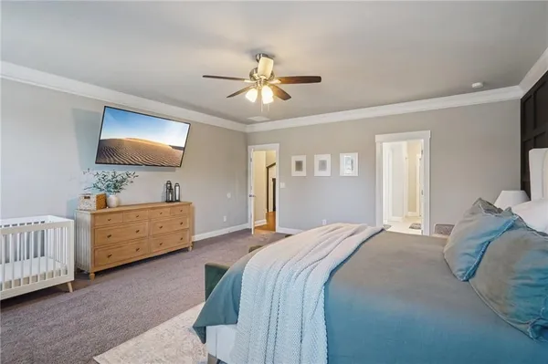 a bedroom with a large bed and a chandelier