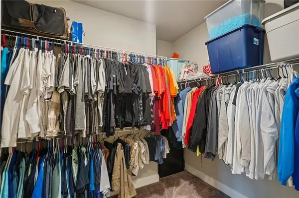 a living room with furniture a flat screen tv and a window