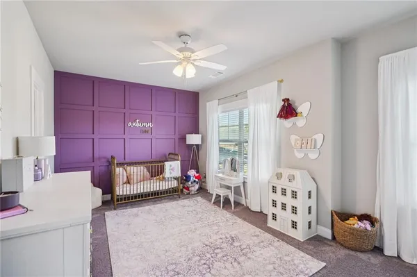 a living room with furniture and a ceiling fan