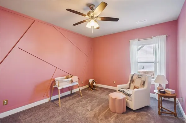 a living room with furniture a flat screen tv and a large window