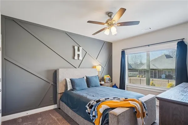 a view of a dining room with furniture large windows and wooden floor