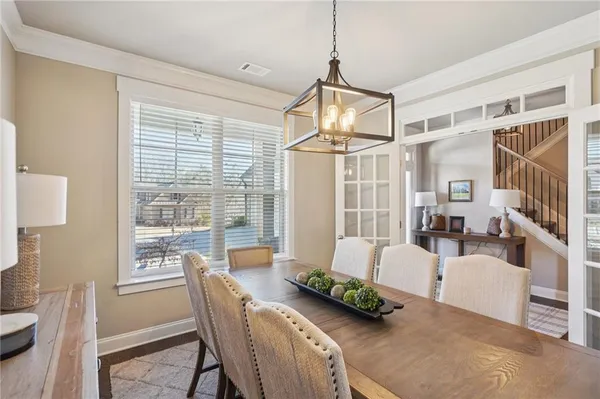 a living room with lots of furniture and view of kitchen