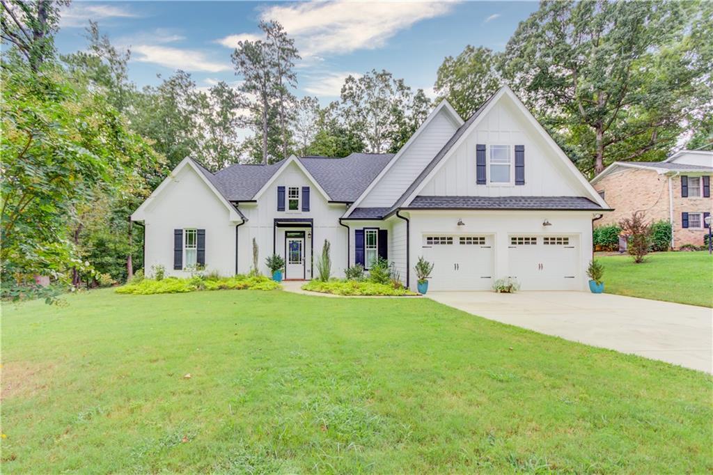 5400 Brownlee Road Southwest Stone Mountain, GA 30087 - Photo 1 of 1 a view of an house with backyard and garden