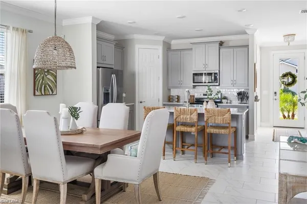 a dining room with furniture and window