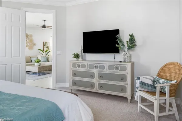 a bedroom with furniture and a flat screen tv
