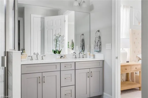 a bathroom with double vanity sinks and a mirror